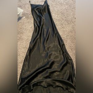 long silk black dress with silver chains as straps.